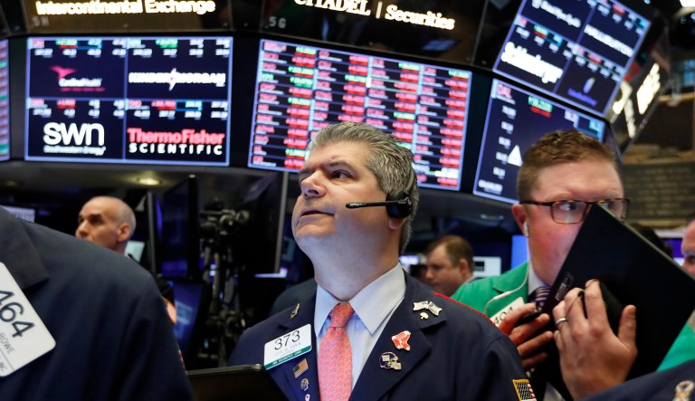 Traders John Panin, center, and Ryan Falvey, right, work on the floor of the New York Stock Exchange, Thursday, May 9, 2019. Stocks are opening broadly lower on Wall Street as investors keep a close eye on trade talks between the U.S. and China.