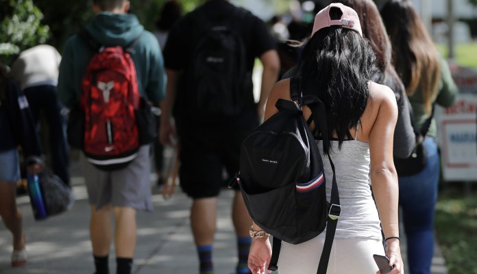 In this Tuesday, Oct. 23, 2018 photo, students walk on the campus of Miami Dade College, in Miami.