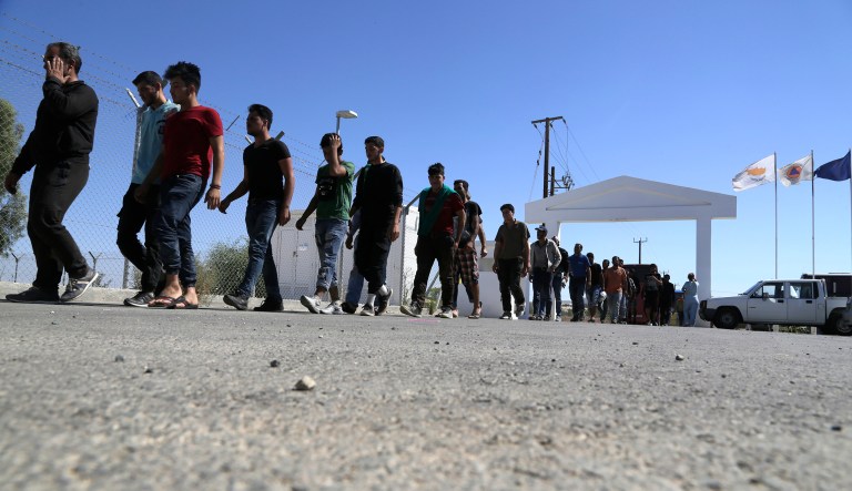 Migrants from Syria walk towards a refugee camp at Kokkinotrimithia, outside of the capital Nicosia, in the eastern Mediterranean island of Cyprus, on Sunday, Sept. 10, 2017.