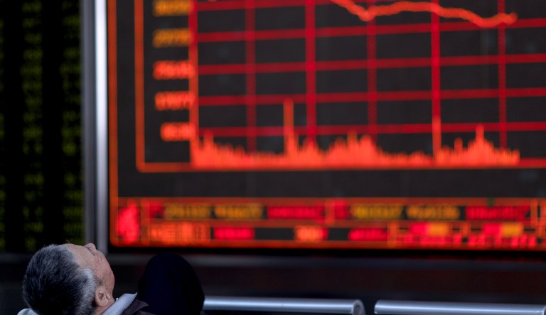 A Chinese investor watches as the Shanghai Composite Index falls at a brokerage In Beijing on Monday, May 6, 2019. China's benchmark Shanghai Composite index dives on Trump threat of more China tariffs.