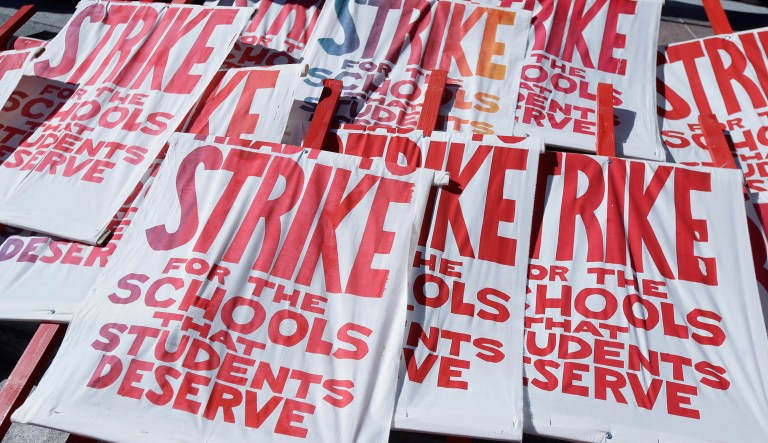 In this Feb. 21, 2019 photo picket signs are shown as teachers, students and supporters at a rally at Frank Ogawa Plaza in front of City Hall in Oakland, Calif.