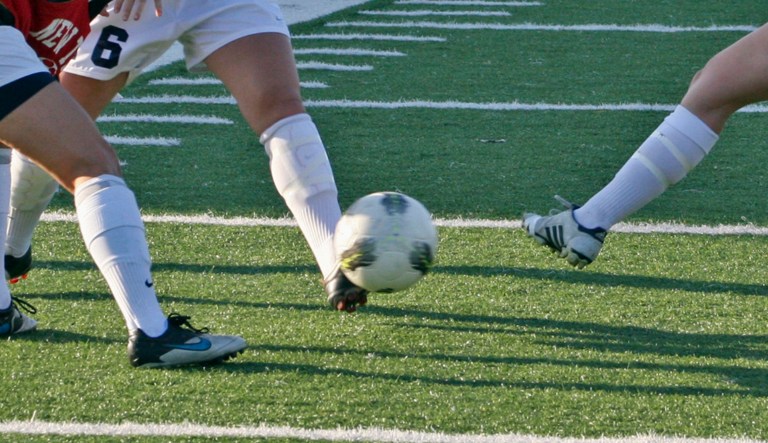 In a May 22, 2012 photo, Aly Marzonie, right, and Rachel Shellenback, second from right, team captains of the New Trier High School girls' soccer team, kick a ball with teammates as they prepare for a game in the Illinois High School Association girls' soccer tournament in Skokie, Ill.  Girls like those on the New Trier soccer team are reaping the benefits of Title IX, the federal amendment that opened up sports opportunities to girls and women 40 years ago. But some say there's still more progress to be made for girls in sports.