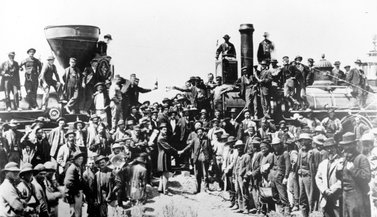 Railroad officials and employees celebrate the completion of the first railroad transcontinental link in Prementory, Utah on May 10, 1869. The Union Pacific's Locomotive No. 119, right, and Central Pacific's Jupiter edged forward over the golden spike that marked the joining of the nation by rail.