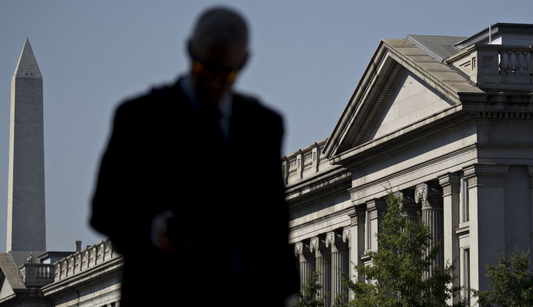 A pedestrian walks near the U.S. Treasury building in Washington, D.C., U.S., on Monday, July 16, 2018. 