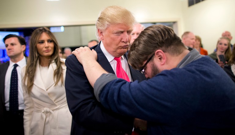 FILE - In this Jan. 31, 2016, file photo, Pastor Joshua Nink, right, prays for Republican presidential candidate Donald Trump, as wife, Melania, left, watches after a Sunday service at First Christian Church, in Council Bluffs, Iowa. The list of prominent evangelicals denouncing Trump is growing, but is anyone in the flock listening?  The bloc of voters powering the real estate mogul through the Republican primaries is significantly weighted with white born-again Christians. As Trumpâs ascendancy forces the GOP establishment to confront how it lost touch with so many conservative voters, top evangelicals are facing their own dark night, wondering what has drawn so many Christians to a twice-divorced, profane casino magnate with a muddled record on abortion and gay marriage.