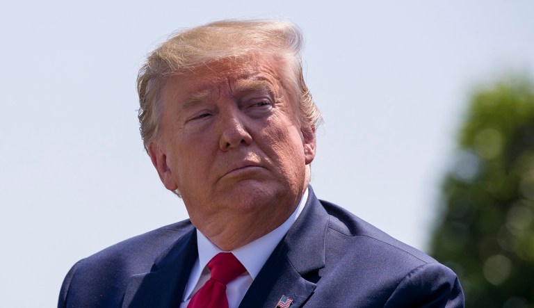 President Donald Trump is seated during a full honors welcoming ceremony for Secretary of Defense Mark Esper at the Pentagon, Thursday, July 25, 2019, in Washington.