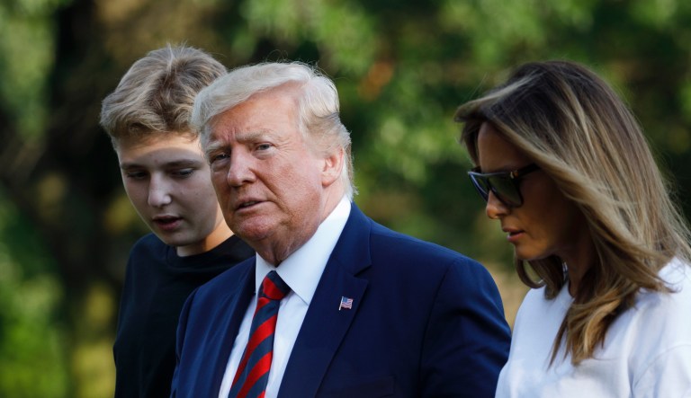 Donald Trump, right, sits with, from left, Eric Trump, Donald Trump Jr., and Ivanka Trump during a ground breaking ceremony for the Trump International Hotel on the site of the Old Post Office, on Wednesday, July 23, 2014, in Washington. 