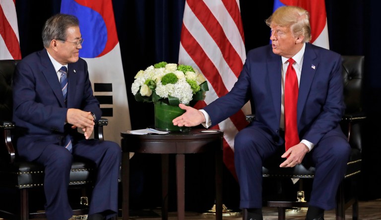 People watch a TV screen showing images of North Korean leader Kim Jong Un, right, South Korean President Moon Jae-in, center, and U.S. President Donald Trump at the Seoul Railway Station in Seoul, South Korea, Wednesday, March 7, 2018. After years of refusal, North Korean leader Kim Jong Un is willing to discuss the fate of his atomic arsenal with the United States and has expressed a readiness to suspend nuclear and missile tests during such talks, a senior South Korean official said Tuesday. Korean letters on the screen read: "Thawing Korean Peninsula."