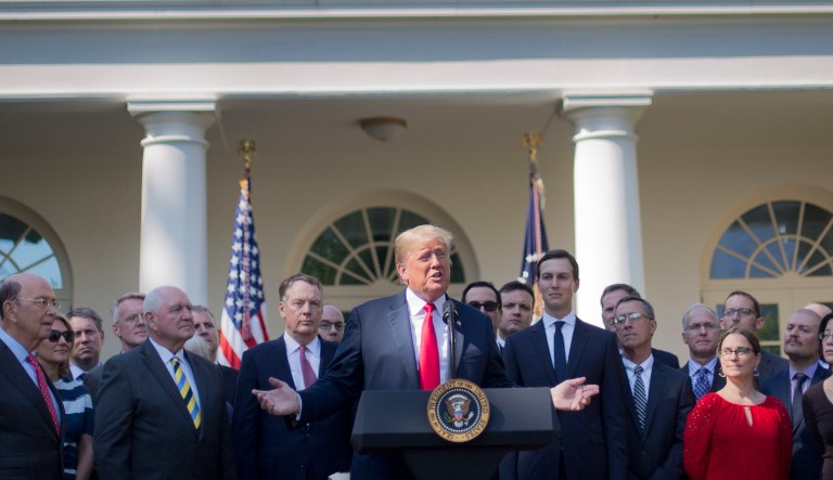 President Donald Trump, center, speaks as he announces a revamped North American free trade deal, in the Rose Garden of the White House in Washington, Monday, Oct. 1, 2018. The new deal, reached just before a midnight deadline imposed by the U.S., will be called the United States-Mexico-Canada Agreement, or USMCA. It replaces the 24-year-old North American Free Trade Agreement, which President Donald Trump had called a job-killing disaster.