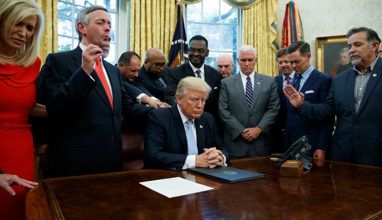 Faith leaders pray with President Donald Trump after he signed a proclamation for a national day of prayer to occur on Sunday, Sept. 3, 2017, in the Oval Office of the White House, Friday, Sept. 1, 2017, in Washington.