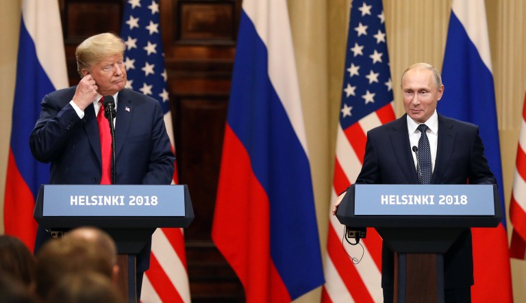 U.S. President Donald Trump, left, adjusts his earpiece as Vladimir Putin, Russia's President, reacts during a news conference in Helsinki, Finland, on Monday, July 16, 2018. Trump said a two-hour, one-on-one meeting with Putin was a âgood startâ on Monday for their Helsinki summit, but gave no indication he had relented to increased pressure to confront the Kremlin leader over election meddling.