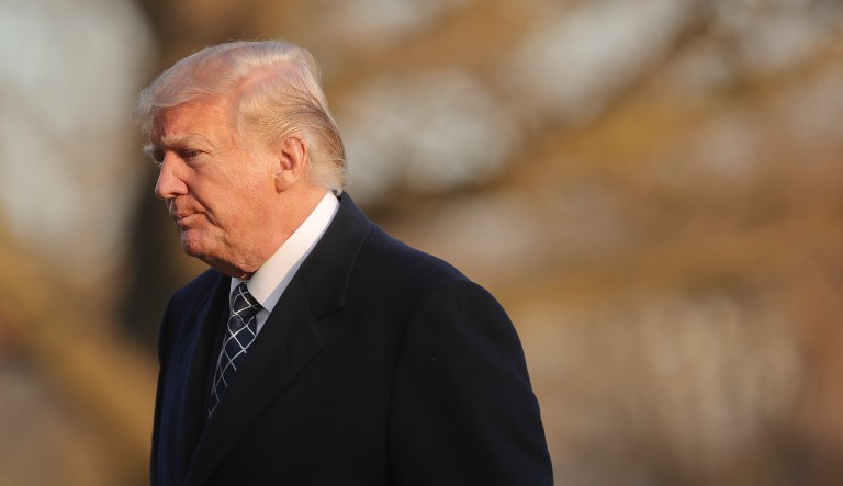U.S. President Donald Trump walks across the South Lawn of the White House in Washington, Sunday, March 25, 2018, after returning from his Mar-a-Lago estate in Palm Beach, Fla.