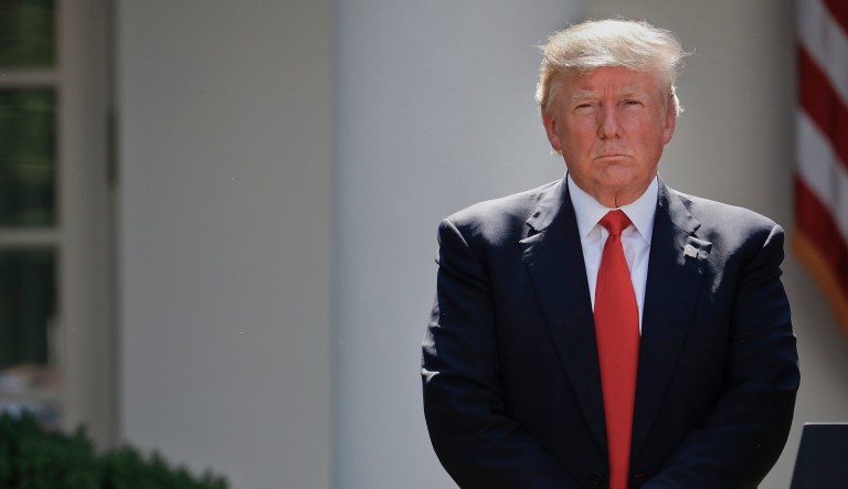President Donald Trump stands next to the podium after speaking about the U.S. role in the Paris climate change accord, Thursday, June 1, 2017, in the Rose Garden of the White House in Washington.
