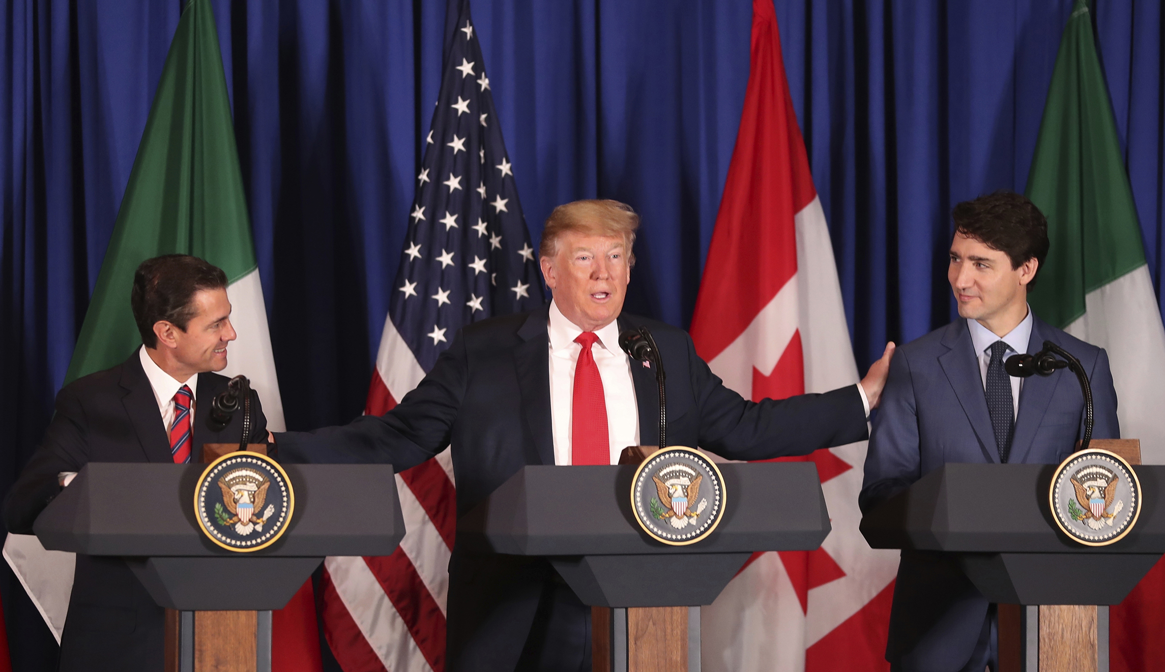 Trump signs USMCA trade deal, which if approved by Congress would update NAFTA