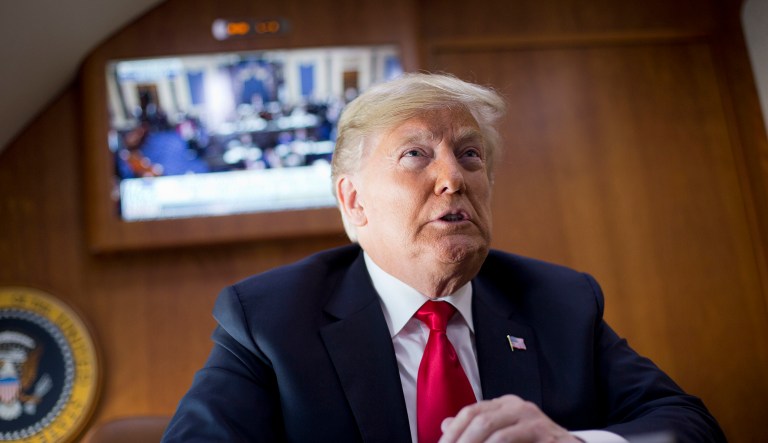President Donald Trump, on board Air Force One, watches a live television broadcast of the Senate confirmation vote of Supreme Court nominee Brett Kavanaugh, Saturday, Oct. 6, 2018. Trump was traveling from Washington enroute to Topeka, Kan., for a campaign rally.