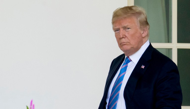 President Trump holds up examples of tariffs, Thursday, Jan. 24, 2019, in the Cabinet Room of the White House in Washington. 