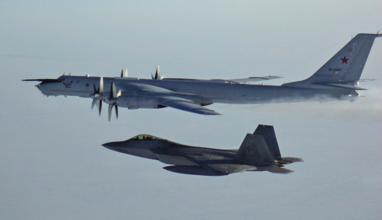 In this Monday, March 9, 2020 photo released by the North American Aerospace Defense Command (NORAD), a Russian Tu-142 maritime reconnaissance aircraft, top right, is intercepted near the Alaska coastline. U.S. and Canadian aircraft intercepted and escorted two Russian jets that flew over the Beaufort Sea near the Alaska coastline, military officials said Tuesday.