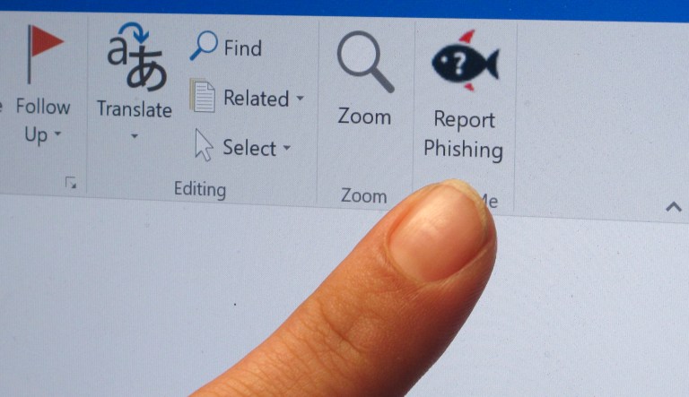 A security analyst points to a button that Ohio State University email users can click to report suspected phishing messages, Friday, March 30, 2018.