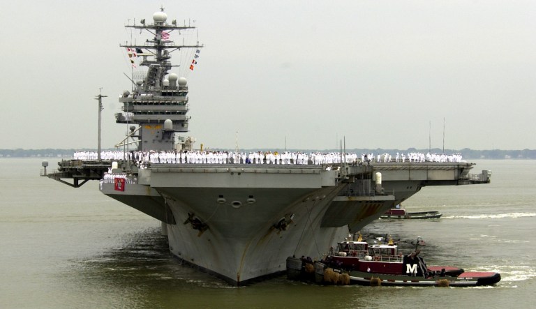 Sailors man the rails as the USS Theodore Roosevelt is manuvered into it's berth at the Norfolk  Naval Station in Norfolk, Va., Thursday May 29, 2003.  The nuclear powered aircraft carrier returned from a five month deployment during which it took part in the war in Iraq.