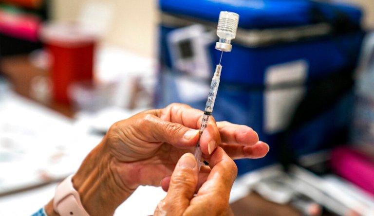 In this Sept. 14, 2021, file photo, a vaccine provider prepares a dose of the COVID-19 vaccine at a clinic run by the Allegheny County Health Department at Casa San Jose, a nonprofit organization serving Latino immigrants in the Beechview neighborhood of Pittsburgh.
