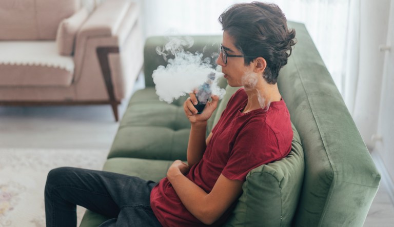Richmonder Coleman Wheeler emits a cloud of smoke from a vape pipe at a local vape shop in Richmond, Va., Friday, Jan. 18, 2019. Tobacco-friendly Virginia is preparing to raise the age limit on buying traditional and electric cigarettes from 18 to 21. 