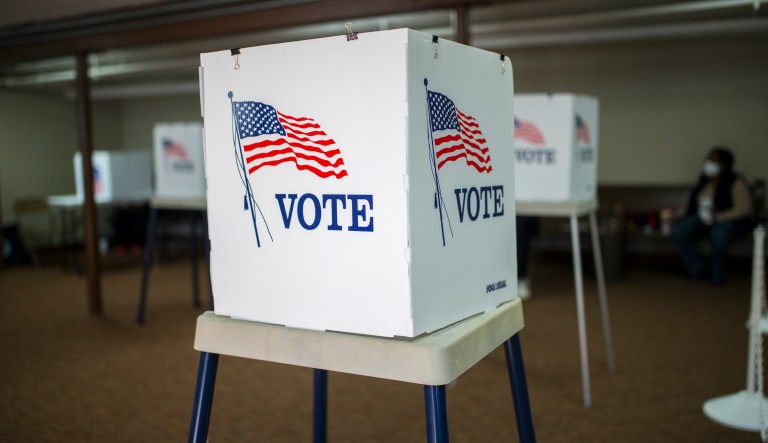 A man votes on the only machine working shortly after polls opened in Georgia's Senate runoff elections at a senior center, Tuesday, Jan. 5, 2021, in Acworth, Ga. Election systems in the U.S. are vulnerable to cyber intrusions similar to the one that hit federal agencies and numerous businesses last year and remain a potential target for foreign hacking, according to a report released Wednesday, Feb. 10, 2021.