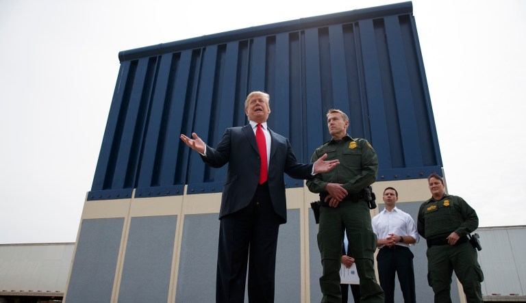 President Donald Trump talks with reporters as he reviews border wall prototypes, Tuesday, March 13, 2018, in San Diego.