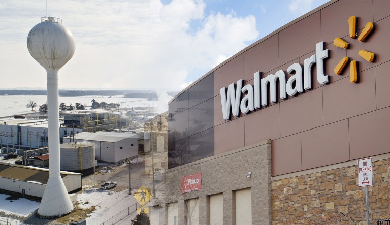A JBS USA Holdings Inc. pork production facility is seen in an aerial photograph taken over Beardstown, Ill., on the left. A Walmart building is seen on the right.