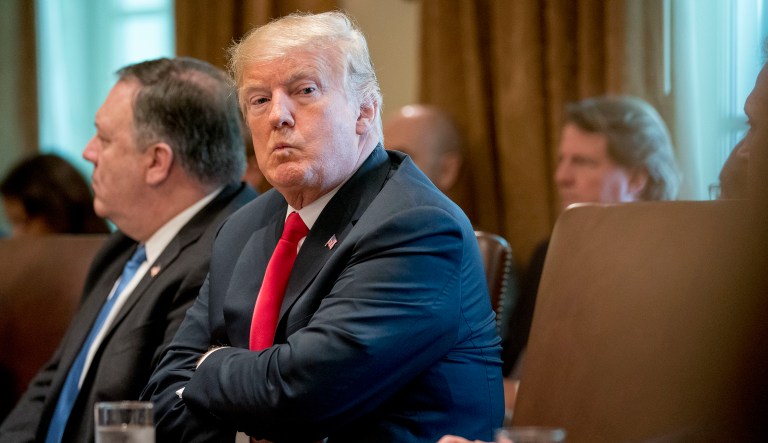 President Donald Trump, accompanied by Secretary of State Mike Pompeo, left, looks around the room during a cabinet meeting in the Cabinet Room of the White House, Thursday, Aug. 16, 2018, in Washington.