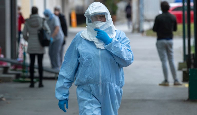 A health worker wears protective suit at the infectious disease clinic in Zagreb, Croatia, where the first coronavirus case in Croatia is hospitalized, Tuesday, Feb. 25, 2020. 