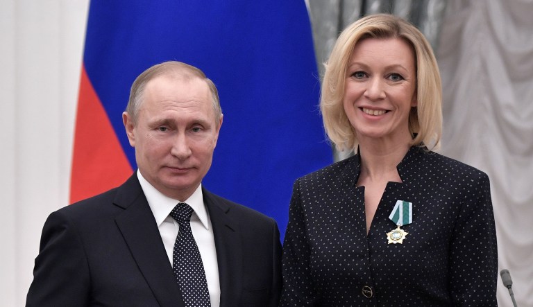 Russian President Vladimir Putin, left, poses for a photo with Foreign Ministry spokeswoman Maria Zakharova during an awarding ceremony in Moscow's Kremlin, Russia, Thursday, Jan. 26, 2017.