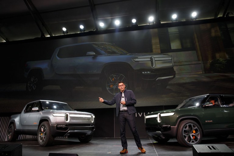 RJ Scaringe, founder and chief executive officer of Rivian Automotive Inc., unveils the R1T electric pickup truck, left, and R1S electric sports utility vehicle (SUV) during a reveal event at AutoMobility LA ahead of the Los Angeles Auto Show in Los Angeles, California, U.S., on Tuesday, Nov. 27, 2018. 