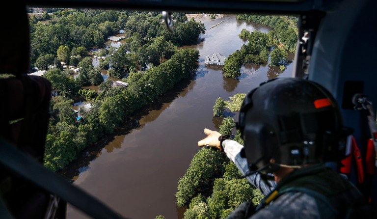 FILE - Sgt. Destry Riggs scans flooded areas during a search and rescue operation run by the 36th Combat Aviation Brigade of the Texas Army national Guard over areas hit by Tropical Storm Harvey on Friday, Sept. 1, 2017, north of Beaumont, Texas. (Brett Coomer/Houston Chronicle via AP)