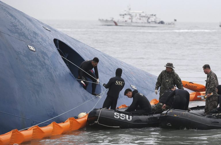 FILE - In this Thursday, April 17, 2014 file photo, South Korean rescue team members try to rescue passengers trapped in the ferry Sewol sinking in the water off South Korea's southern coast near Jindo. Internal partitions in the ferry have become waterlogged and started to bend, said government task force spokesman Ko Myung-seok. Coast guard officials said this can prevent divers from entering different parts of the ferry. Ko also said divers were unable to carry out underwater searches Saturday because of bad weather. (AP Photo/Yonhap, File) KOREA OUT