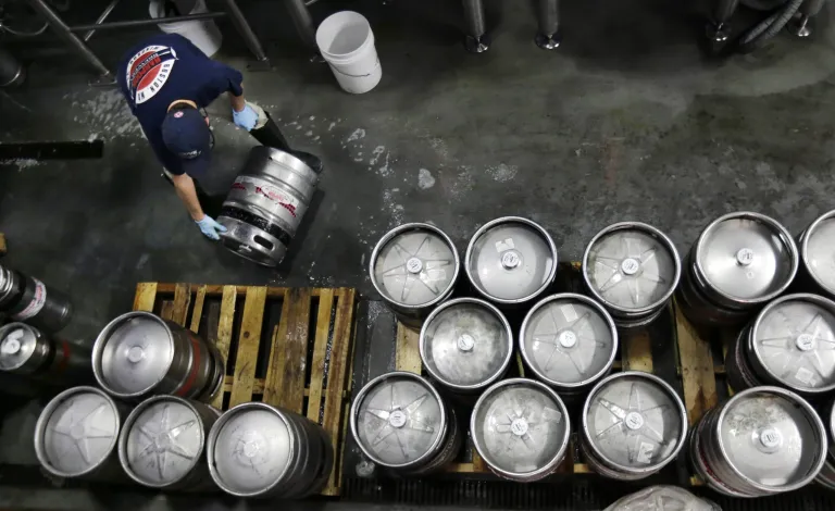 FILE - In this July 1, 2013, file photo, brewer Ken Hermann rolls a fresh keg of beer onto pallets at the Harpoon Brewery in the Seaport District of Boston. The Commerce Department releases its report on business inventories for May 2014 on Tuesday, July 14, 2014. (AP Photo/Charles Krupa, File)