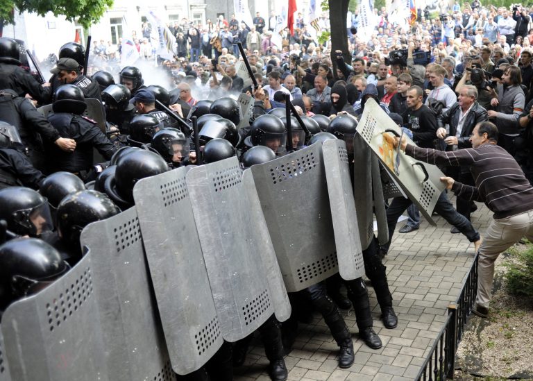 Pro-Russian activists clash with police in front of the regional administration building in Donetsk, Ukraine, Thursday, May 1, 2014. Anti-government demonstrators in Donetsk have stormed the local prosecutor's office. The clash came after a march by several hundred people carrying flags of the Donetsk People's Republic, a movement that seeks either greater autonomy from the central government, or independence and possible annexation by Russia. (AP Photo/Evgeniy Maloletka)