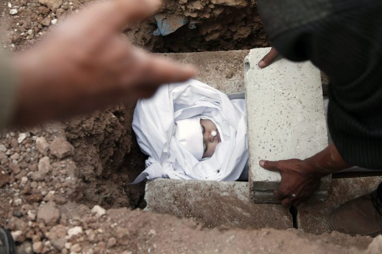  Syrians and Jordanians bury the body of Emara al-Zoabi, 7-months-old, who was killed from Syrian government forces shelling in Ramtha City, north Amman, Jordan, Sunday, Dec. 2, 2012. Al-Zoabi was killed in Tafas village, in the Syrian city of Daraa, on Dec. 1. (AP Photo/Mohammad Hannon)  