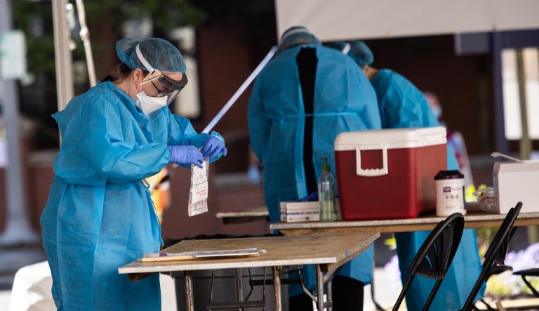 Healthcare workers prepare tests for COVID-19 at George Washington University Hospital in Washington, D.C.