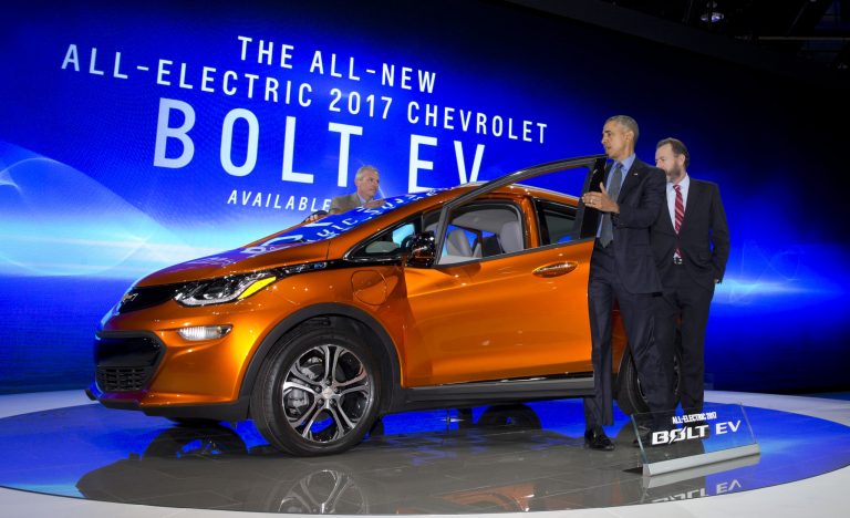 President Obama steps from the new Chevrolet Bolt electric car as Dan Ammann stands right and Patrick Foley stands left during a tour of the 2016 North American International Auto Show in Detroit on Jan. 20. (AP Photo)