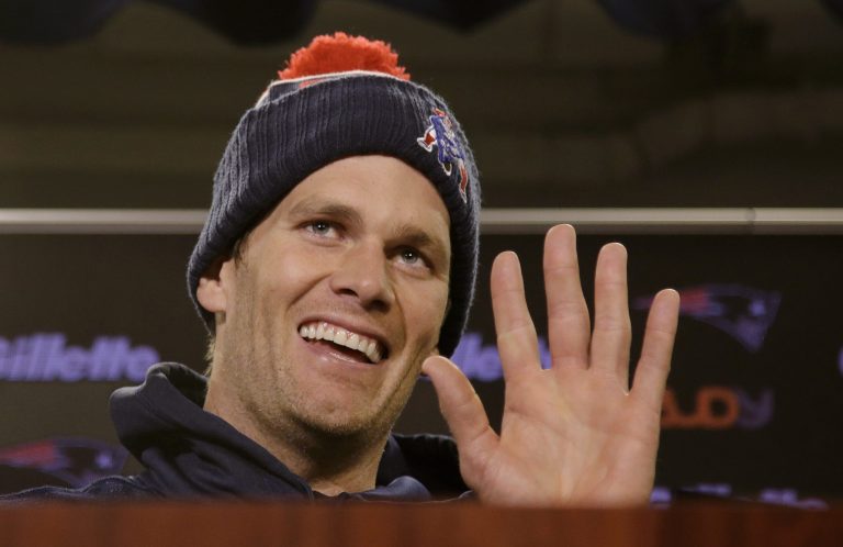 New England Patriots quarterback Tom Brady smiles and waves goodbye to the media after being asked by a reporter about his supposed friendship with Republican presidential hopeful Donald Trump. (AP Photo/Stephan Savoia)