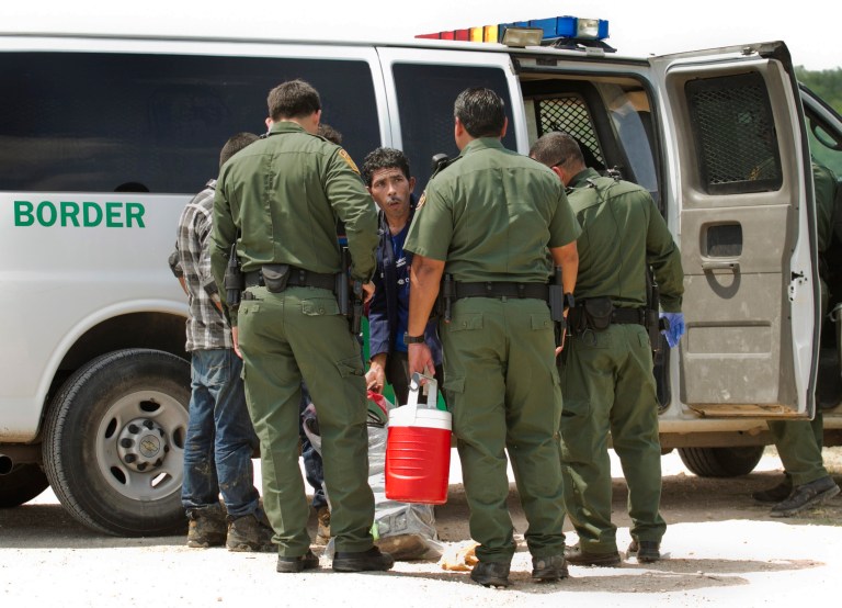 U.S. Border Patrol agents apprehend men who crossed the Rio Grande River from Reynosa, Tamaulipas, Mexico in Anzalduas Park in McAllen, Texas, in this Thursday, July 24, 2014 photo. (AP Photo/Austin American-Statesman, Jay Janner)