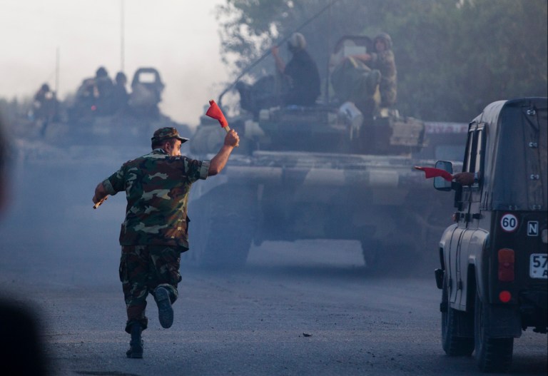 In this Saturday, Aug. 2, 2014, photo a convoy of Azerbaijan's Army tanks moves in the direction of Agdam, Azerbaijan.  Recent days have seen a sharp escalation in fighting between Azerbaijan and Armenia around a tense line of control around Nagorno-Karabakh. (AP Photo/Abbas Atilay)