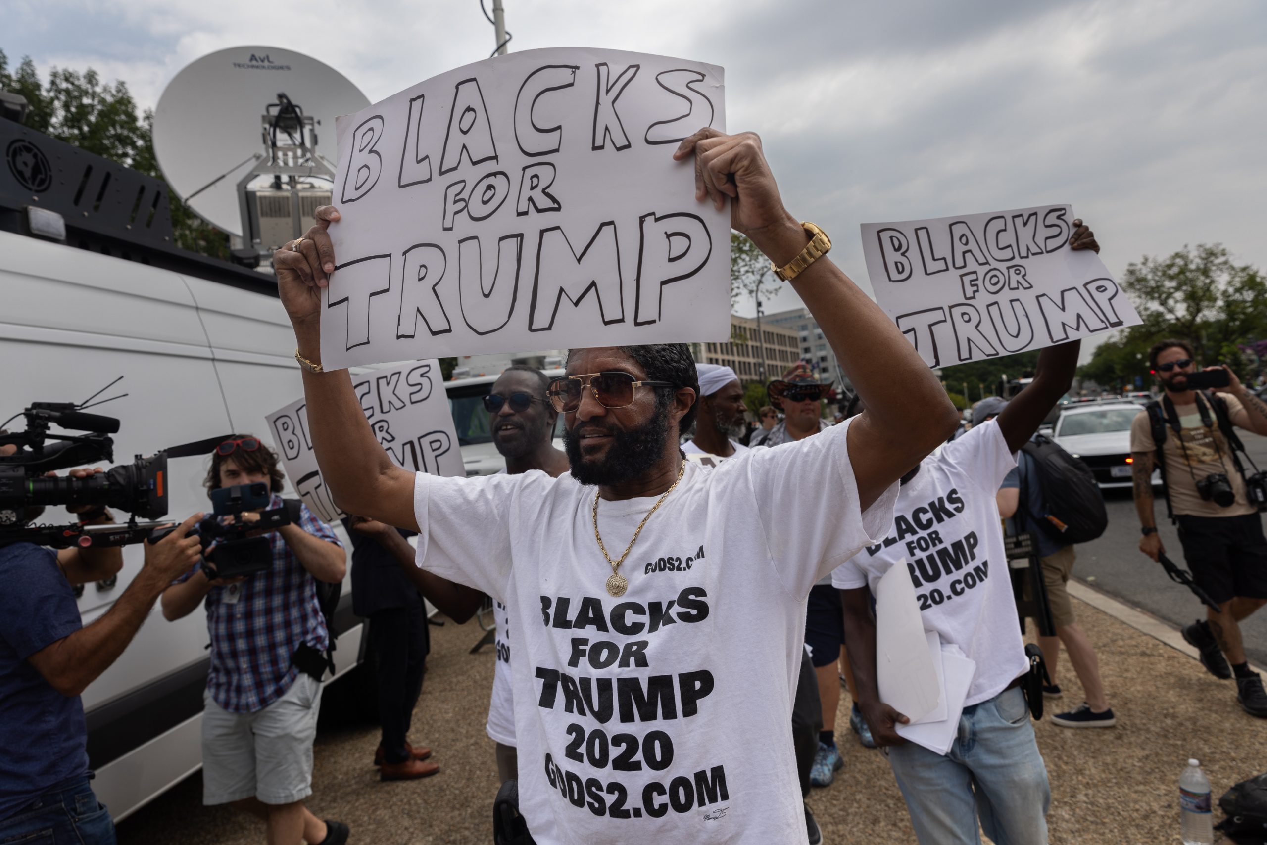 Men hold ÒBlacks for TrumpÓ signs outside the U.S. District Court, on Thursday August 3, 2023. Former President Donald Trump was arraigned on four criminal counts related to his involvement with the January 6 Insurrection, and alleged efforts to overturn the 2020 presidential elections.