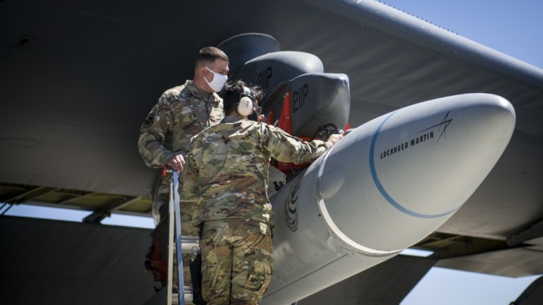 Master Sgt. John Malloy and Staff Sgt. Jacob Puente, both from 912th Aircraft Maintenance Squadron, secure the AGM-183A Air-launched Rapid Response Weapon Instrumented Measurement Vehicle 2 as it is loaded under the wing of a B-52H Stratofortress at Edwards Air Force Base, California, Aug. 6, 2020.
