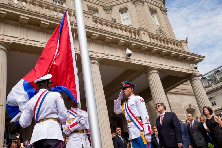 A Cuban honor guard prepares the Cuban flag for Cuban Foreign Minister Bruno Rodriguez, center right, before he raises the Cuban flag over their new embassy in Washington, Monday, July 20, 2015. (AP Photo/Andrew Harnik, Pool)