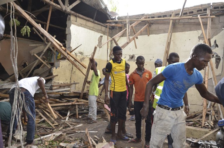Rescue workers gather at the site of an explosion in Maiduguri, Nigeria, Saturday, May 30, 2015. (AP Photo)
