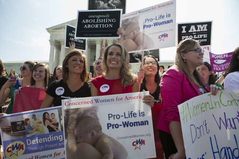 Demonstrators react to hearing the Supreme Court's decision on the Hobby Lobby case outside the Supreme Court in Washington on Monday. (Graeme Jennings/Examiner)