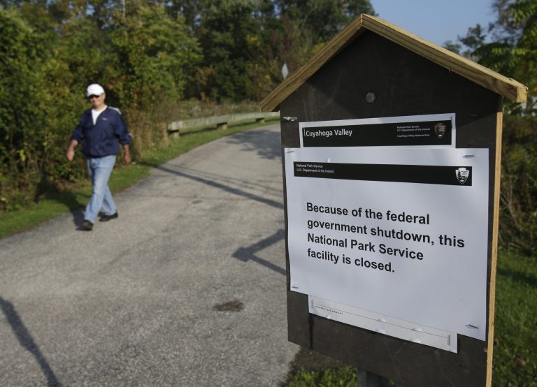 John Carano, 65, walks on a trail at the Cuyahoga Valley National Park Tuesday, Oct. 1, 2013, in Valley View, Ohio. The impacts of the federal shutdown began rippling across Ohio on Tuesday morning, with a national military museum and national park closing and thousands of federal employees going on furlough. (AP Photo/Tony Dejak)