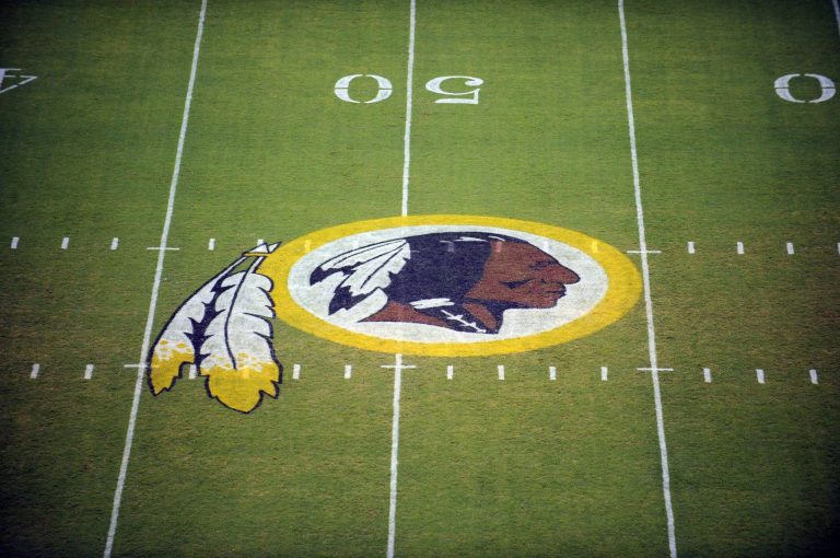 The Washington Redskins' logo is displayed at midfield before the start of a preseason NFL football game in Landover, Md., in 2009. (AP Photo/Nick Wass, File)