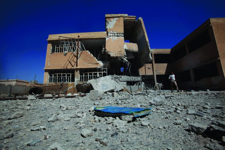 A book is left on the ground at the yard of a school destroyed in government airstrike in Tel Rifaat, on the outskirts of Aleppo, Syria, Sunday, Sept. 16, 2012. A new school year began in Syria on Sunday, but the country's agonizing civil war is keeping thousands of students out of classrooms across the country. Many schools have been destroyed or are home to refugees. Some parents are simply too afraid to send their children to school due over fears of violence. (AP Photo/Muhammed Muheisen)